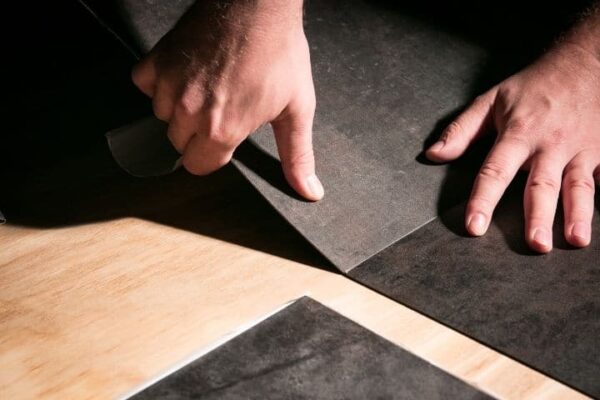 Image depicts a flooring expert installing vinyl floors in a Brampton home.