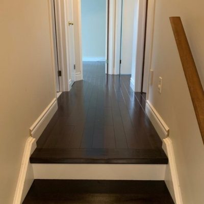 Image depicts a solid hardwood flooring installation project by Flooring Liquidators in London, Ontario.