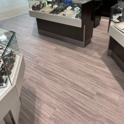 Image depicts new floors from a commercial loose lay vinyl glue down flooring installation project in Brampton, Ontario.