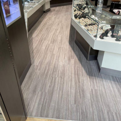 Image depicts new floors from a commercial loose lay vinyl glue down flooring installation project in Brampton, Ontario.