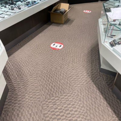 Image depicts old floors from a commercial loose lay vinyl glue down flooring installation project in Brampton, Ontario.