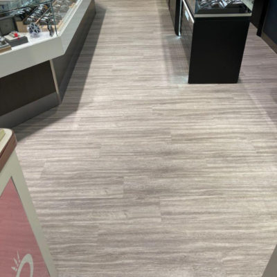 Image depicts new floors from a commercial loose lay vinyl glue down flooring installation project in Brampton, Ontario.